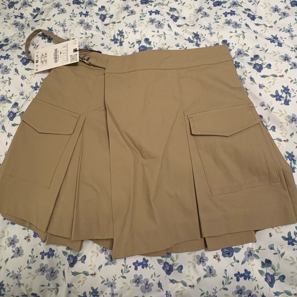 High waist skirt with wrap front and side buckle.
